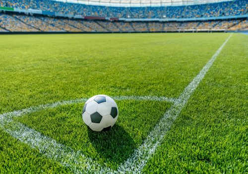 soccer-ball-on-grass-in-corner-kick-position-on-soccer-field-stadium.jpg